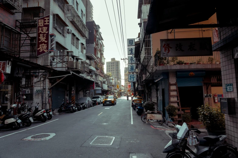 a street with many cars on it and motorcycle riders driving on the road