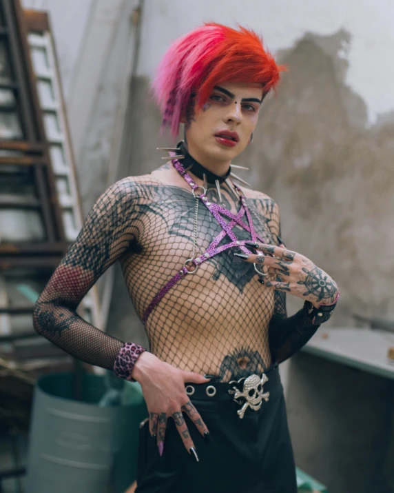 a person wearing a fish net top and tattoos