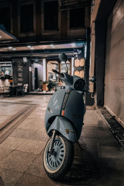an electric scooter parked on the side of a street at night