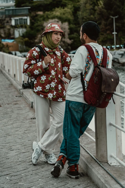 two people standing on a bridge looking around