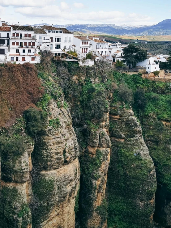 some white buildings on a mountain and trees