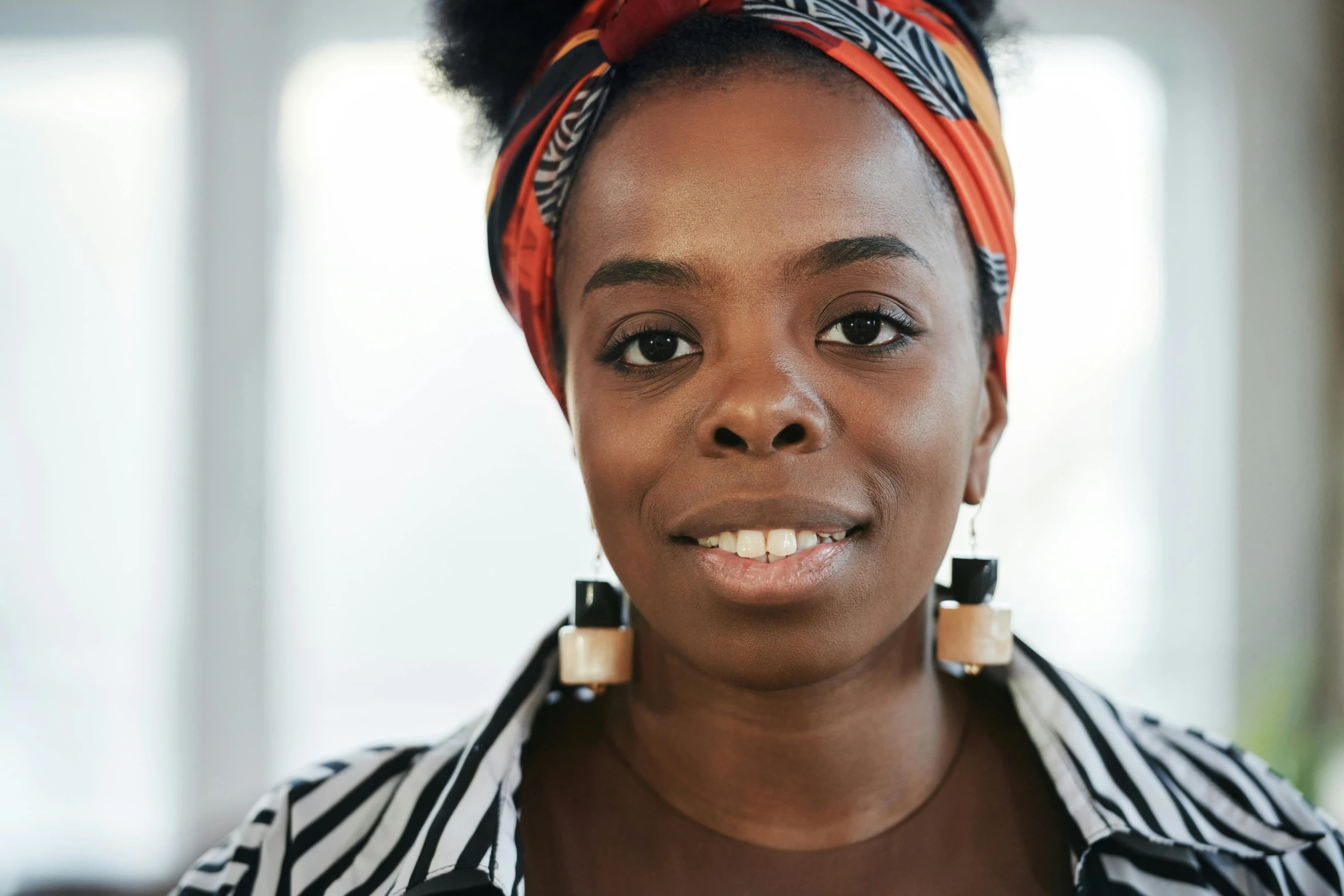 a woman in a striped shirt has a red headband