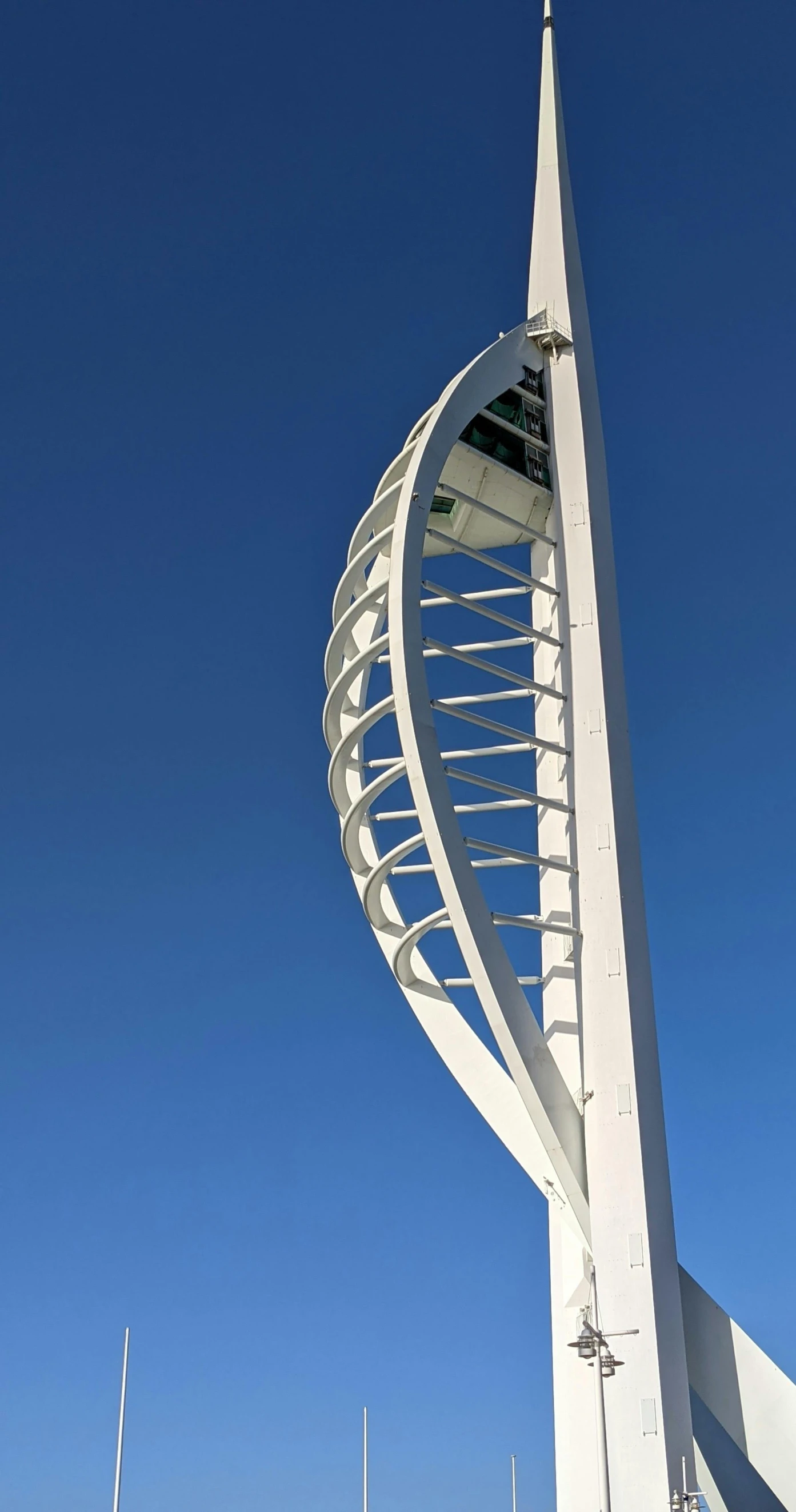 a tall white building with a spiral design