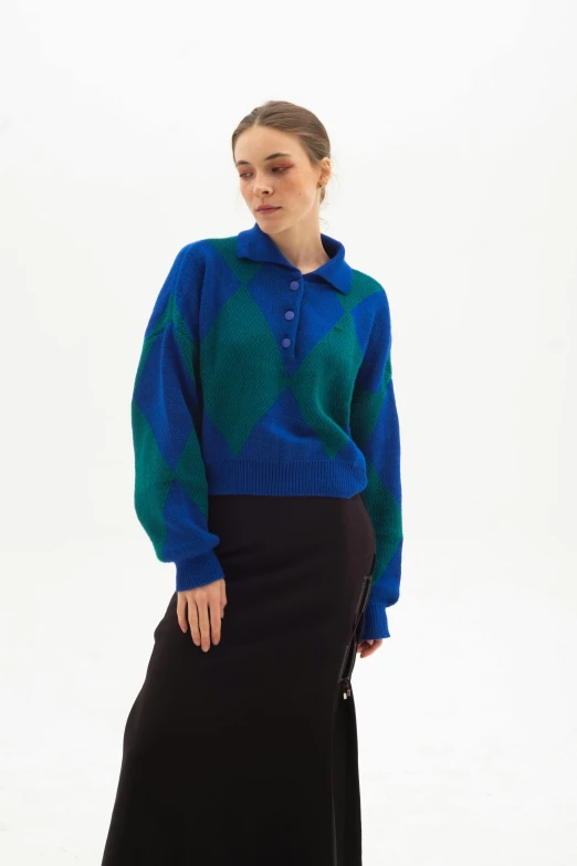 a woman in a blue sweater and black skirt