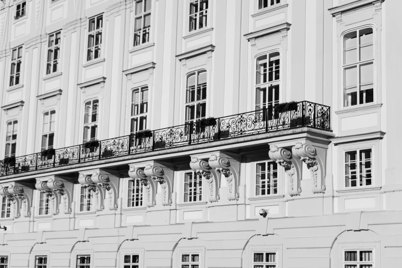 there are several balconies on the top of a white building