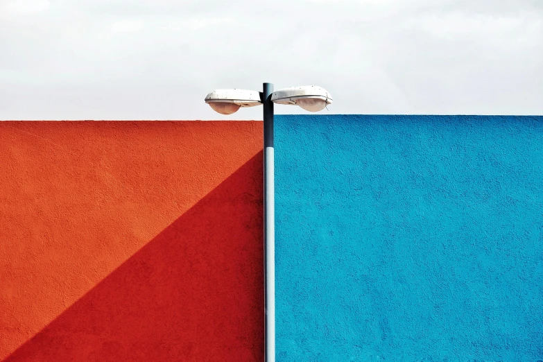 street lights and a blue orange and white wall