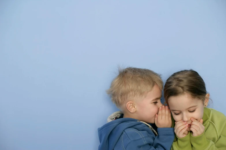 two children are touching noses with each other