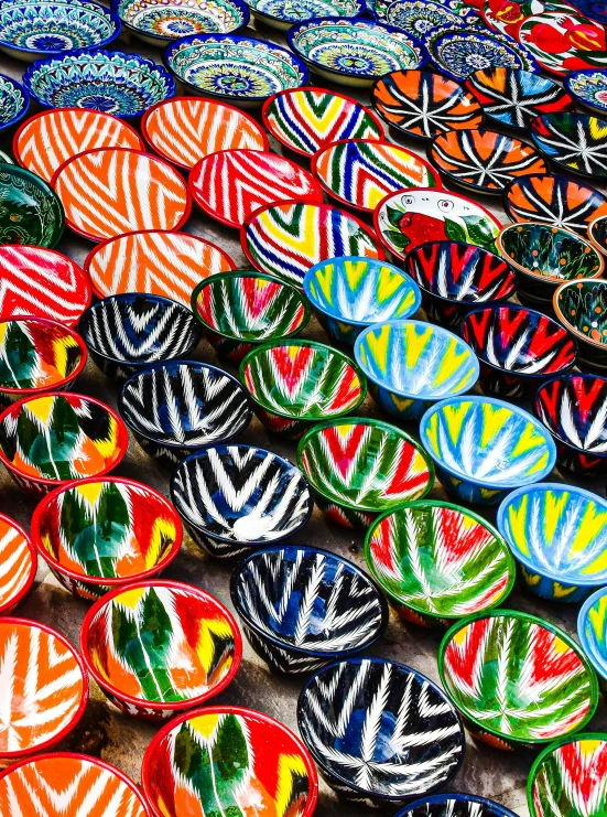 colorful plates in bright colors stacked on a wooden table