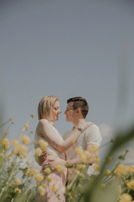 a couple in the middle of yellow flowers