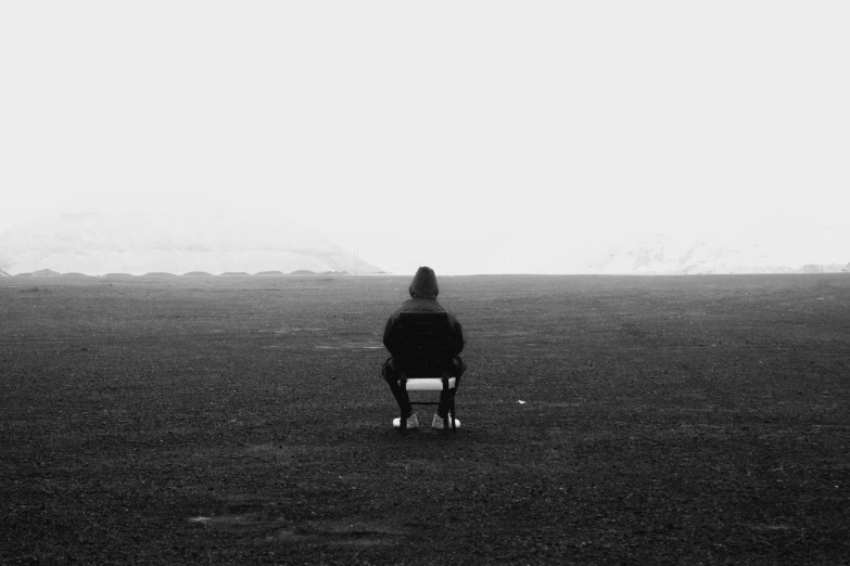 a person sitting on a wheel chair in the middle of a field