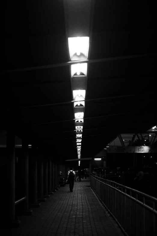 the walkway has no lights or people walking