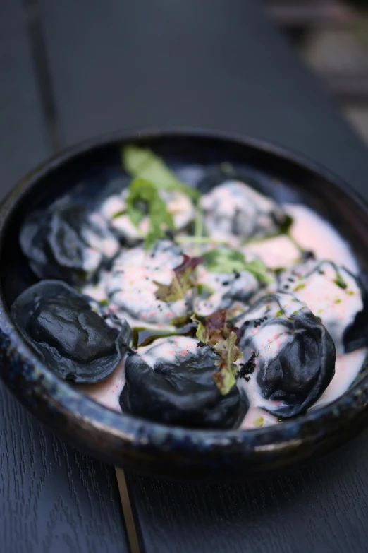 some type of dish of dumpling on a wooden table