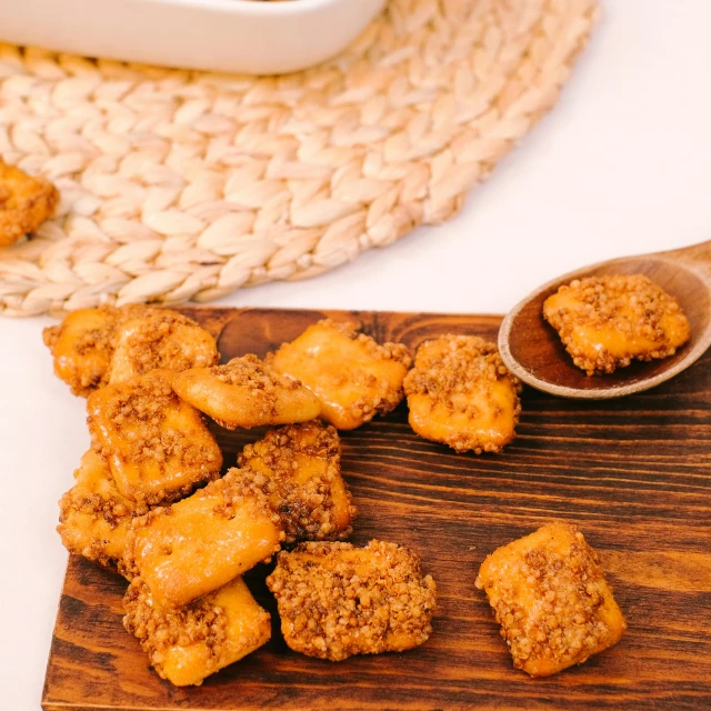 some snacks on a table near a wooden spoon