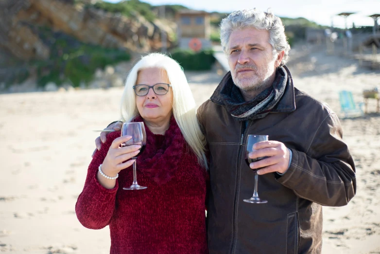 a man and a woman posing for a picture on a beach