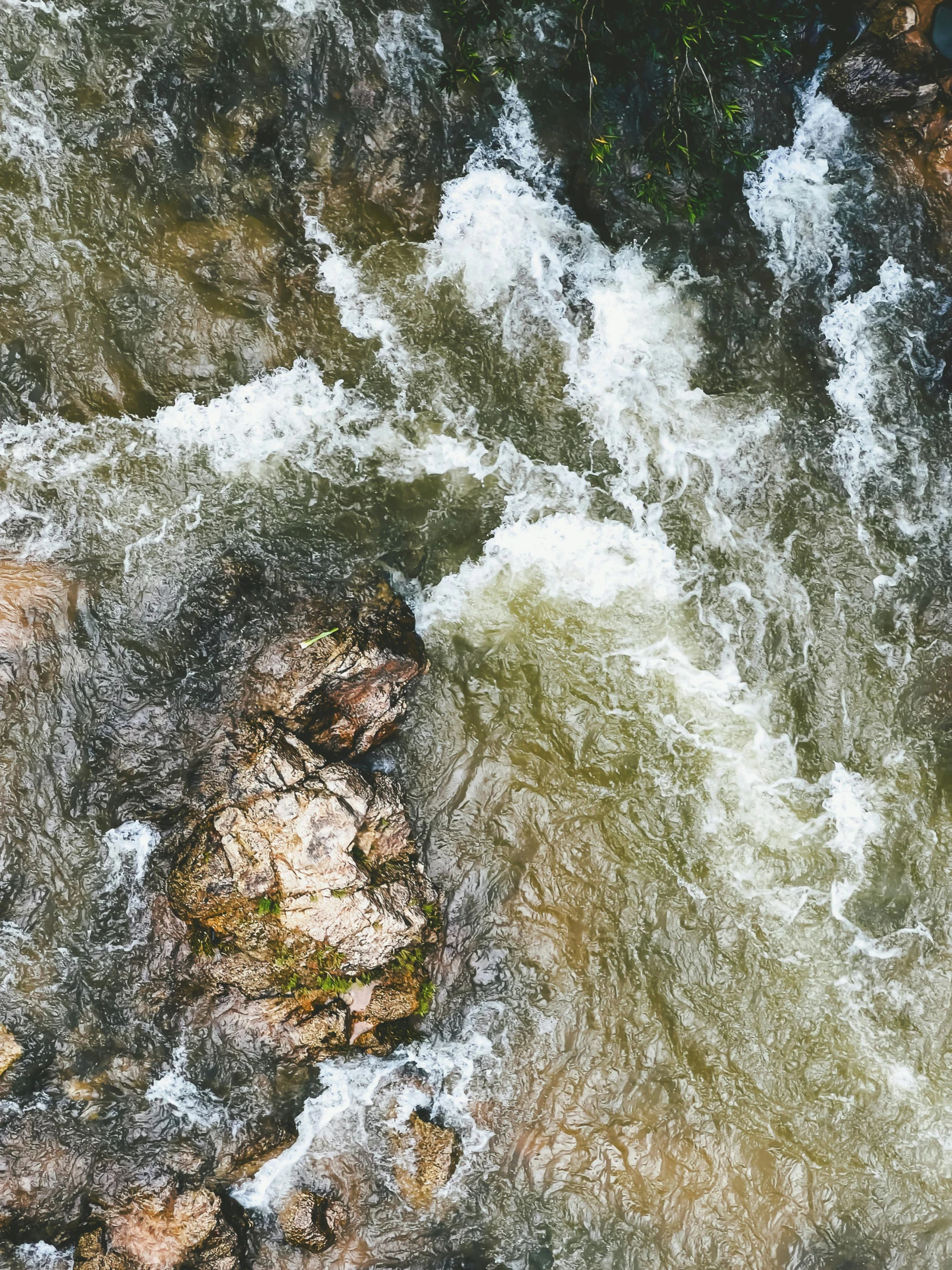 top down view of water rushing over rocks