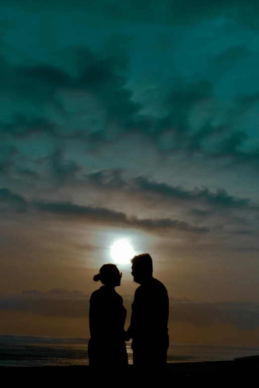 a couple of people that are standing under a light