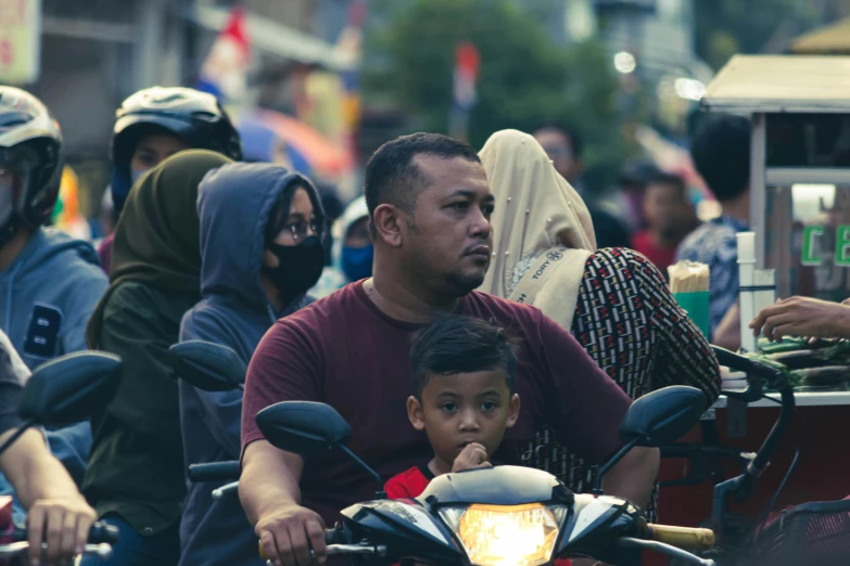 a man and a child on a motorcycle