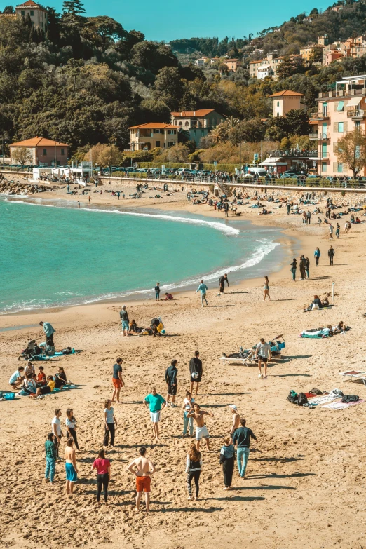 people on the beach near a shoreline and ocean