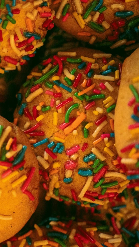 a pile of colorful sprinkles and donuts in a bag