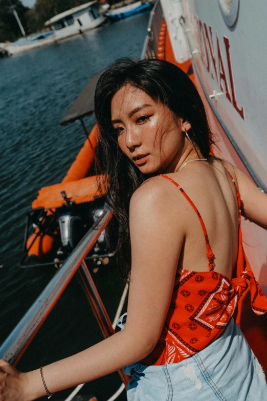 a girl standing next to some orange boats