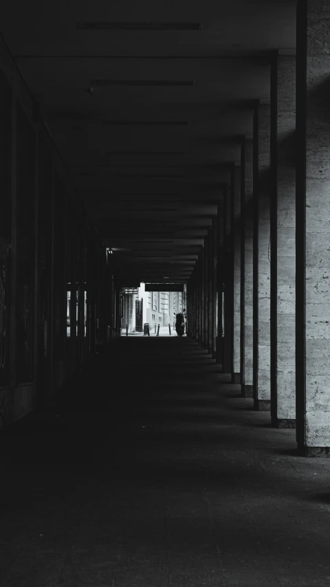 the long hallway in an empty building has no people on it