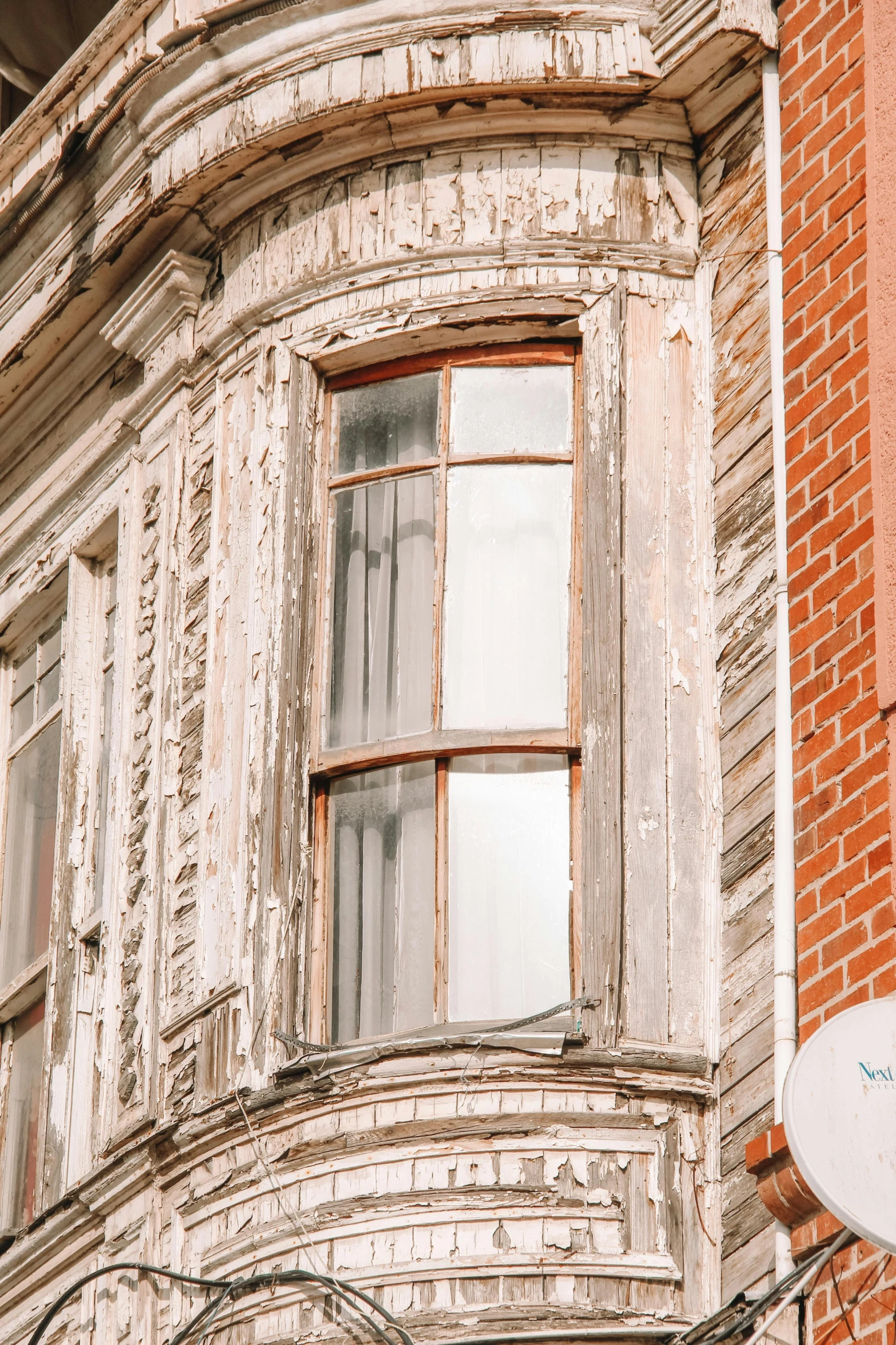 a window with an old brown brick facade