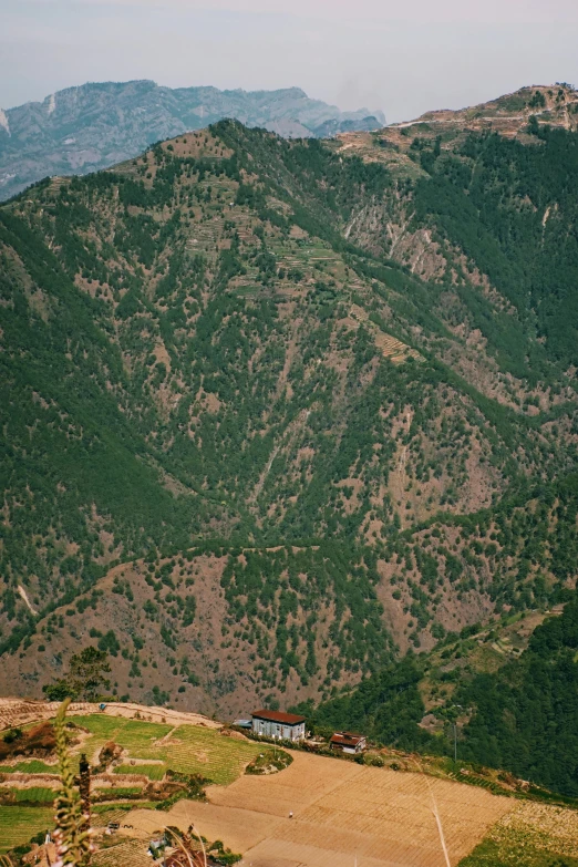 the view of a valley and mountains is taken from a high vantage