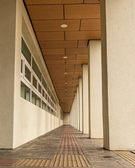 a po taken of a walkway with a row of windows