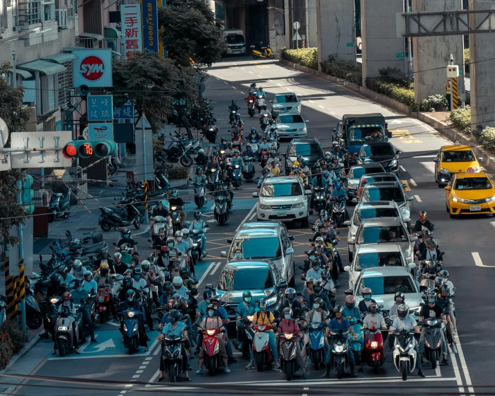 many police motorcycles and cars are stopped in traffic