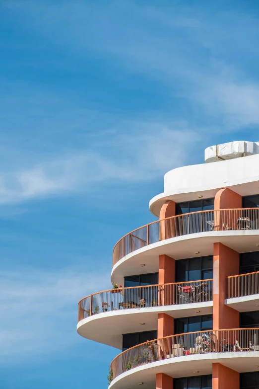 a tall orange building with balconies and balconies