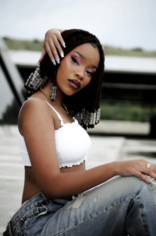 an african american woman wearing jeans and a white crop top