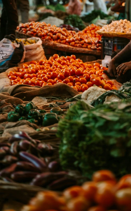 baskets full of red peppers and onions in a market