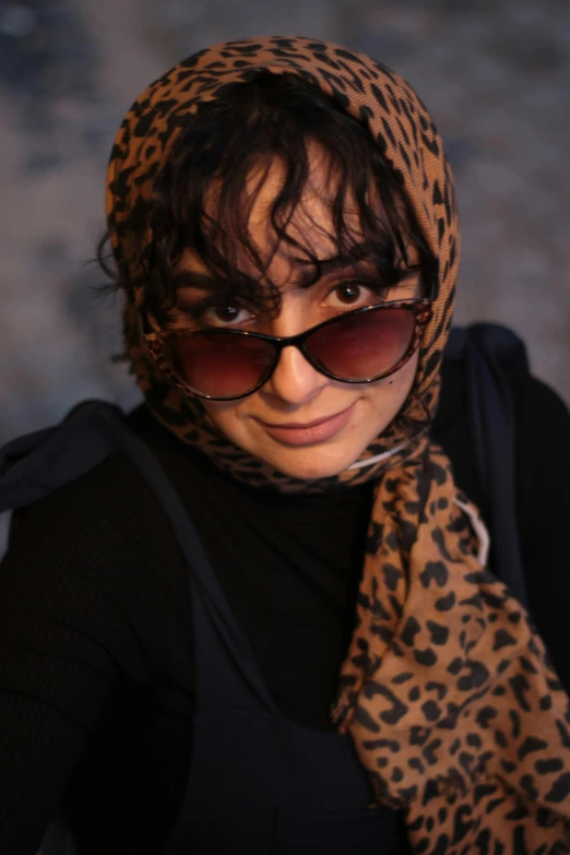 a woman wearing sun glasses and scarf