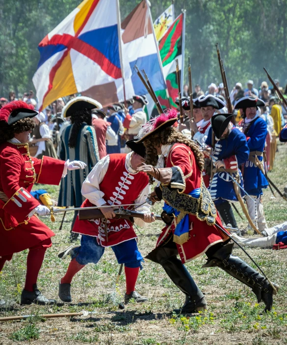 many people in period costumes at a reenactment of a renaissance event