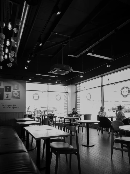 an empty restaurant that has lots of tables and chairs