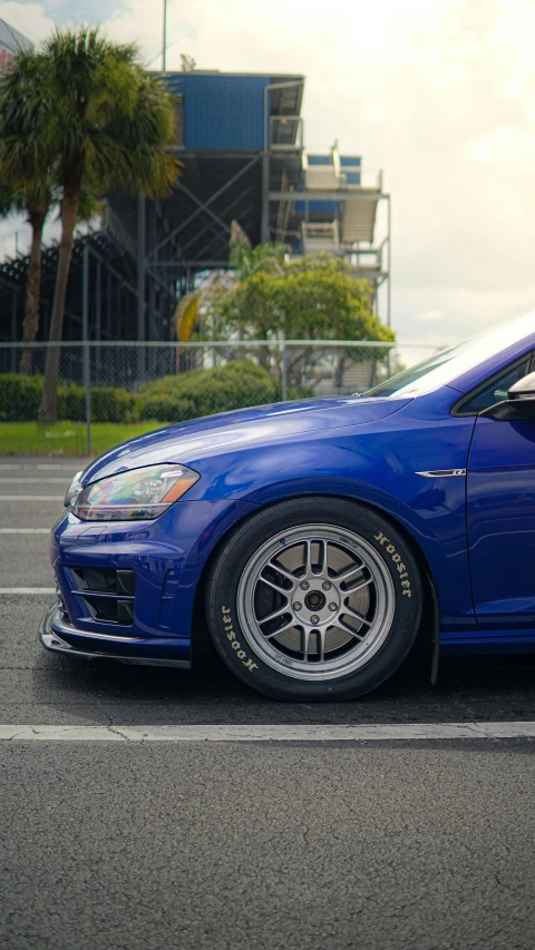 a blue sports car parked in a parking lot