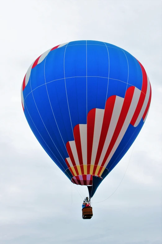 a blue and red  air balloon in the sky