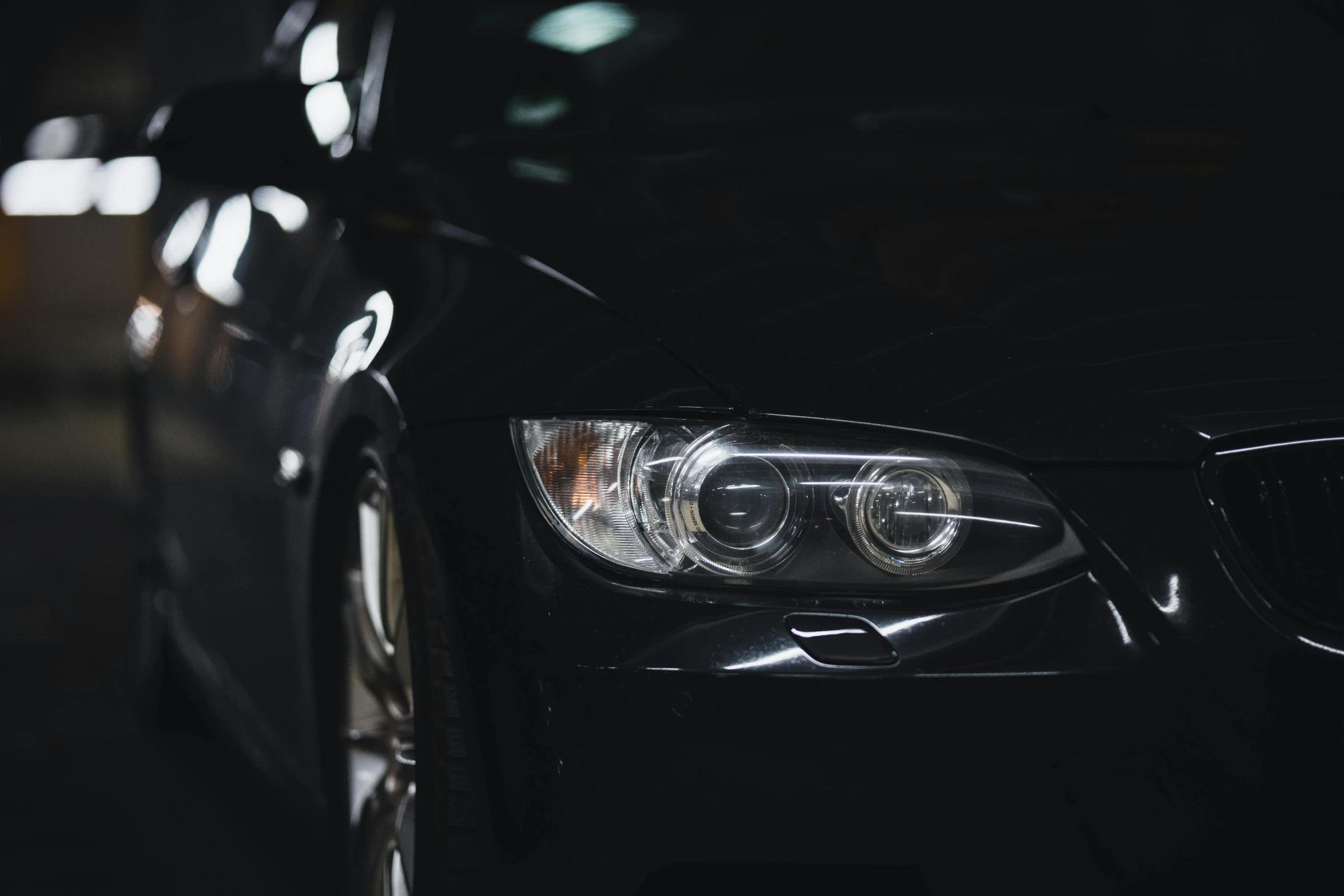 the front lights of a bmw sedan are on