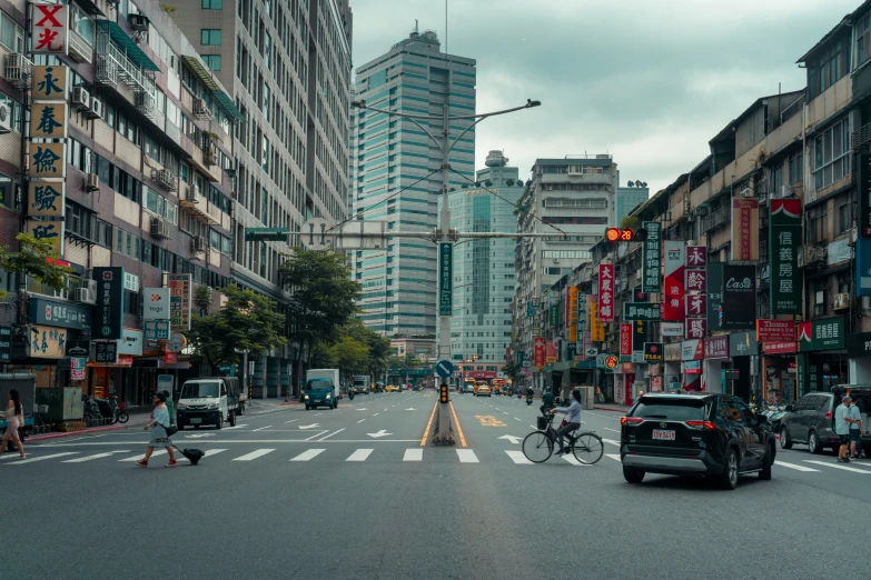 a street scene with buildings on either side and two traffic lights