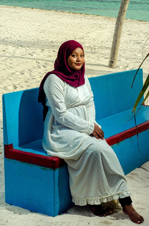 a woman sitting on a bench with her hands folded