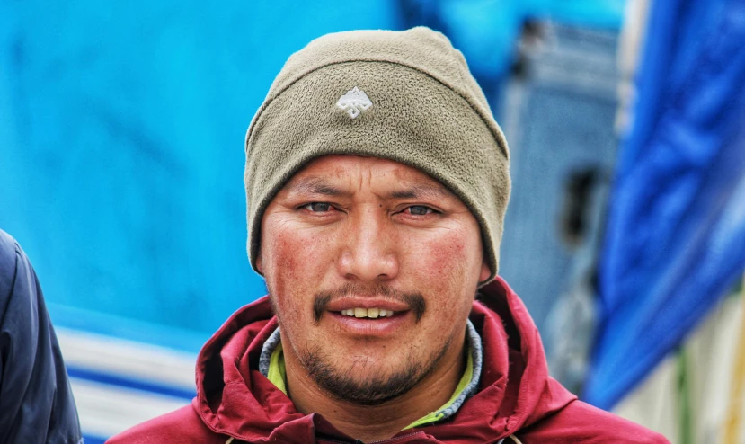 an extreme close up of a person wearing a coat and a hat