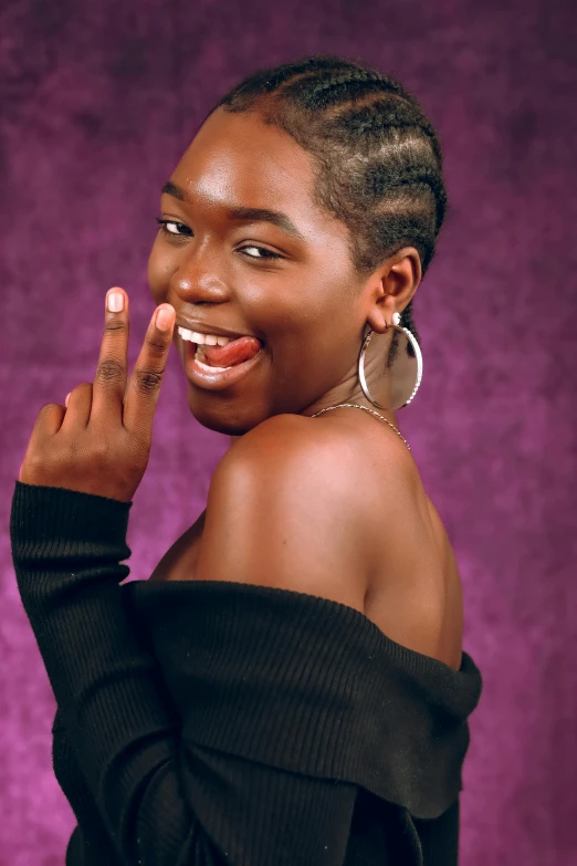 a woman with her fingers up while posing for a portrait