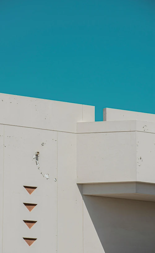 a bird sitting on a ledge and watching soing