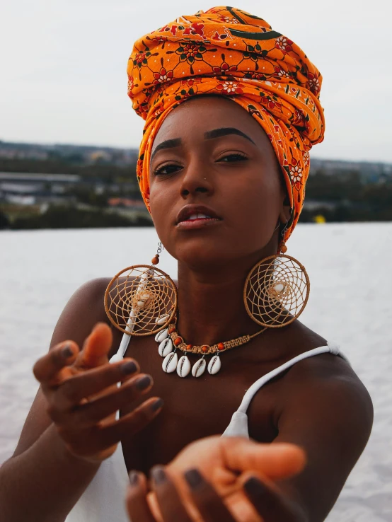 an african woman in headdress holding soing