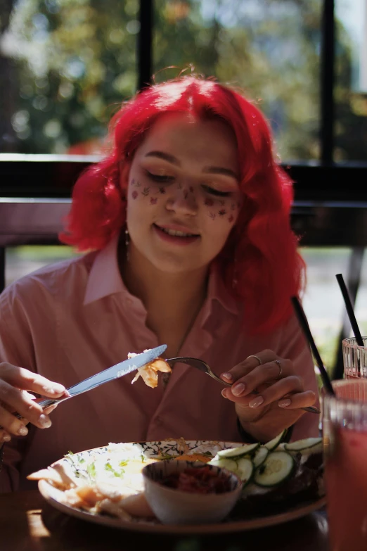 a person sitting at a table eating food