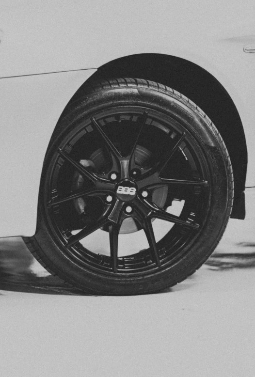 a black and white po of a car wheel