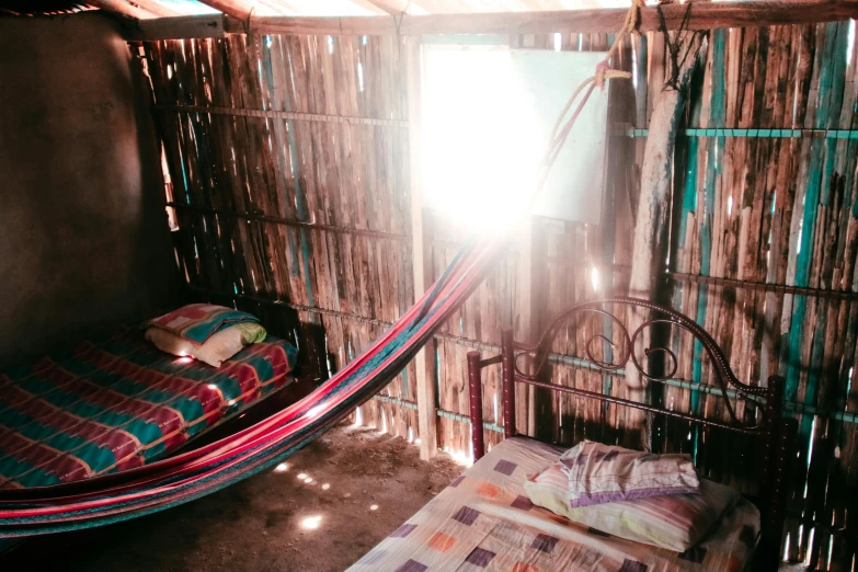 a bed with pillows in a hammock hanging over the top