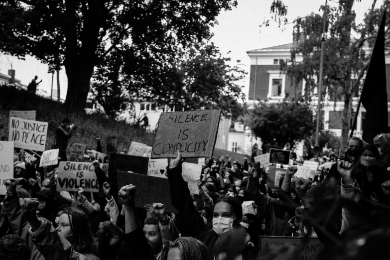 people holding up signs in the street