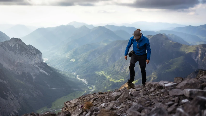 a man standing on top of a rocky mountain