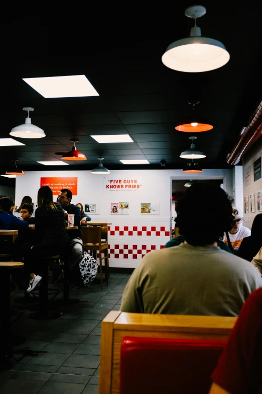 people in a diner with their backs to the camera